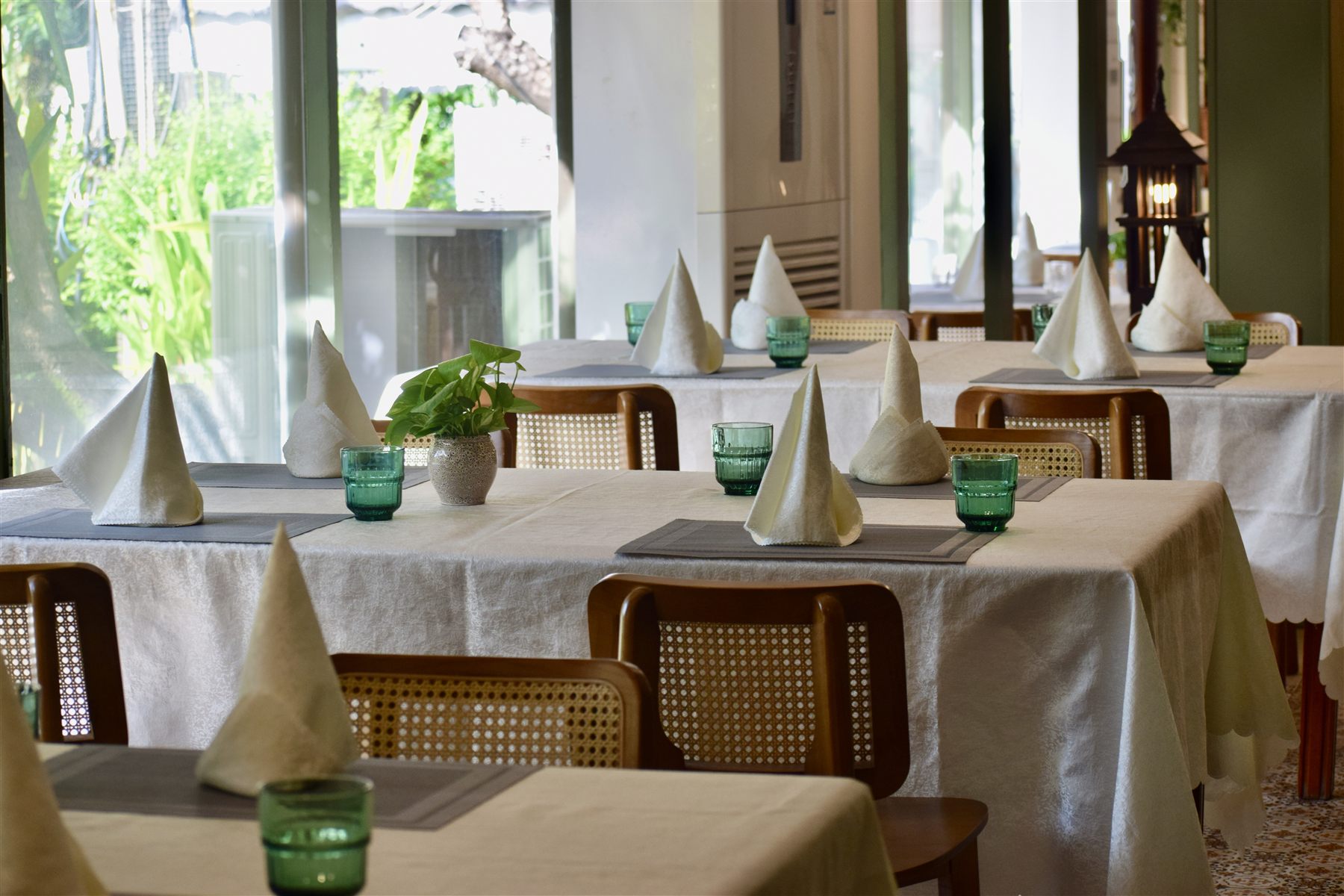 Garden-side dining tables at Tamnak Lao