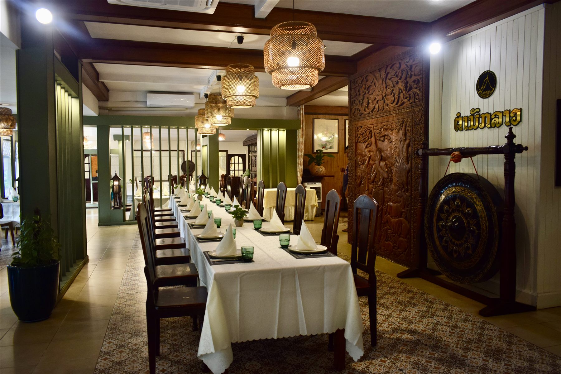 Entrance hall with a ceremonial gong and carved wood panel