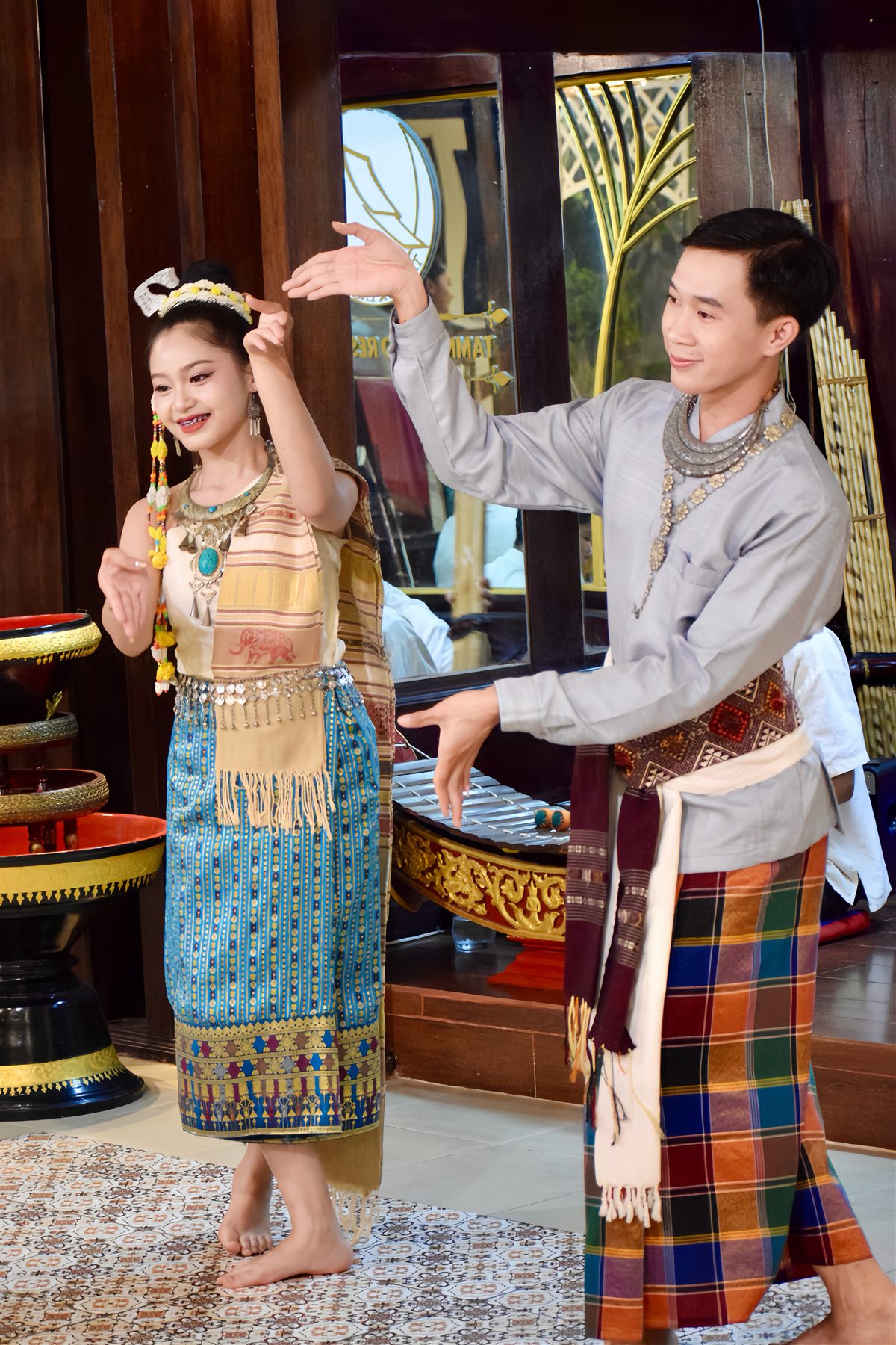 Two dancers performing a traditional Lao dance