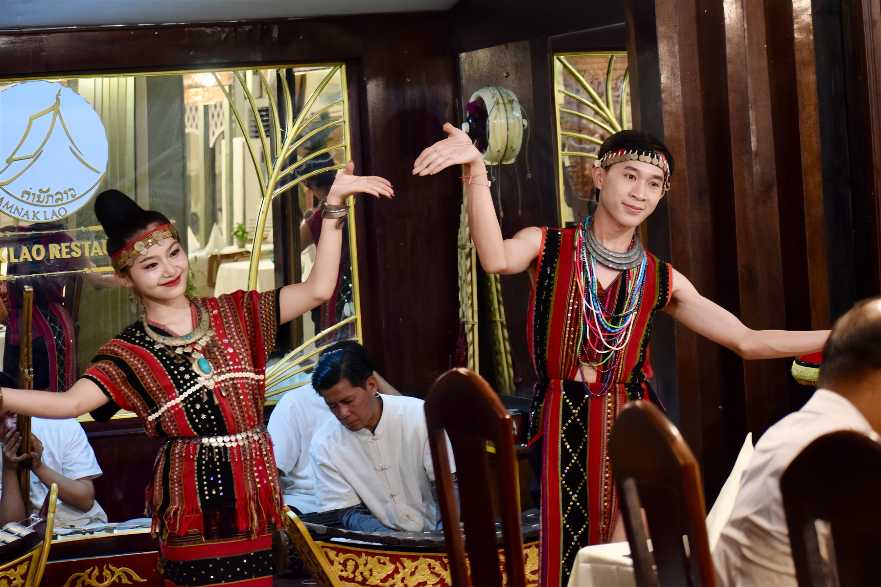 Dancers in traditional Lao dress performing